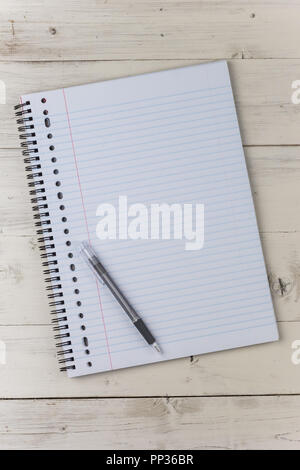 Notepad and pen on a white wooden table Stock Photo
