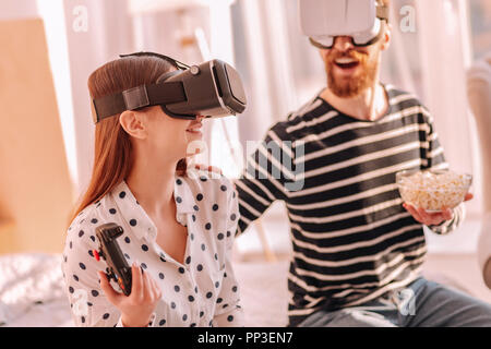 Nice young couple playing video games together Stock Photo