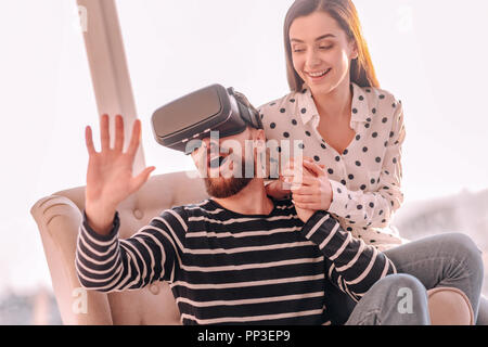 Bearded surprised man wearing virtual reality glasses Stock Photo