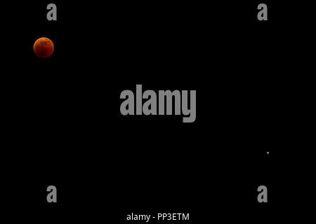 The "blood moon" eclipse of July 27,2018, with the planet mars visible bottom right and various other faint stars. Seen from Greece Stock Photo