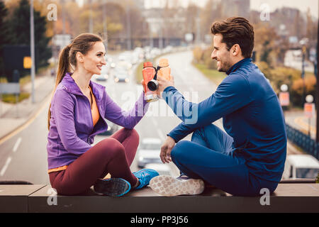 Woman and man drinking water in break from fitness training Stock Photo