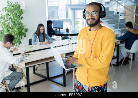 Male designer using laptop Stock Photo