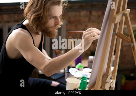 Inspired Young Man Painting Stock Photo