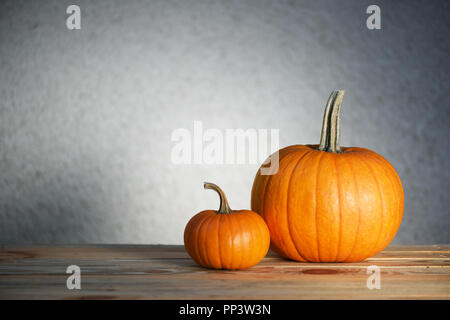 Two pumpkins on wooden table. Halloween and autumn food background Stock Photo