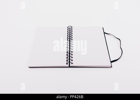 Mock-up open notepad with spring with two blank sheets on white table, close-up. Stock Photo