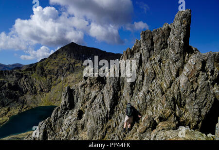 Climber scrambling on a tricky section of Crib Goch Stock Photo