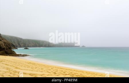 Looking down on Porthcurno Beach on a misty cornish morning,Cornwall,England,UK Stock Photo