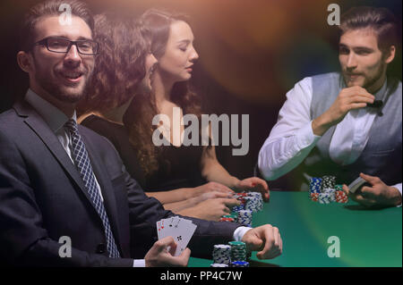 businessman showing four aces sitting at the craps table in the casino Stock Photo