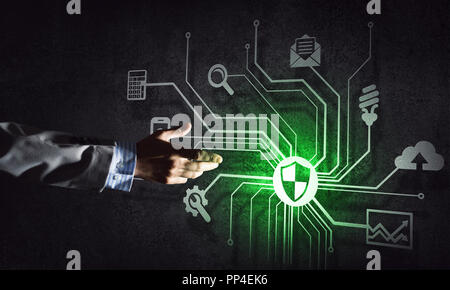 Close of businessman hand showing at user interface glowing on wall Stock Photo