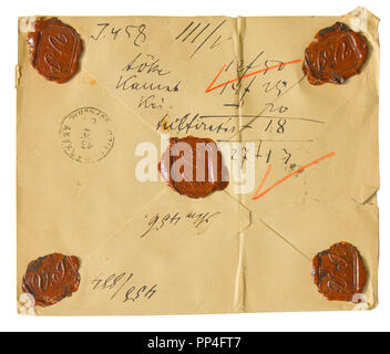 Old vintage yellowed envelope with writing, stamp and red wax seals - isolated on white background Stock Photo