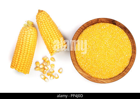 corn groats or cornmeal in wooden bowl and corncob isolated on white background. Top view. Flat lay. Stock Photo