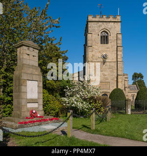 Tower of The Church of St John the Evangelist & village war memorial cenotaph with poppy wreaths at base - East Witton, Northg Yorkshire, England, UK. Stock Photo