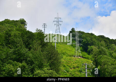 support of high-voltage transmission lines in the mountains Stock Photo