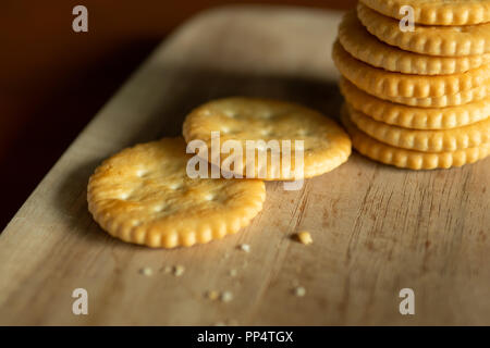 Crispy Crackers on wooden board Stock Photo