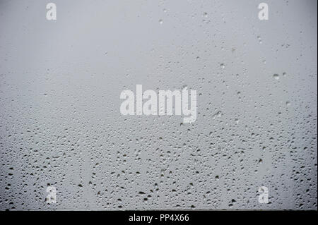 Droplets of water on a window pane - typical Bank Holiday weather in Great Britain Stock Photo