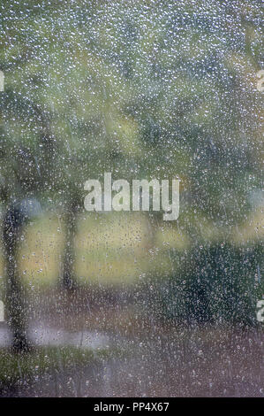 Droplets of water on a window pane - typical Bank Holiday weather in Great Britain Stock Photo