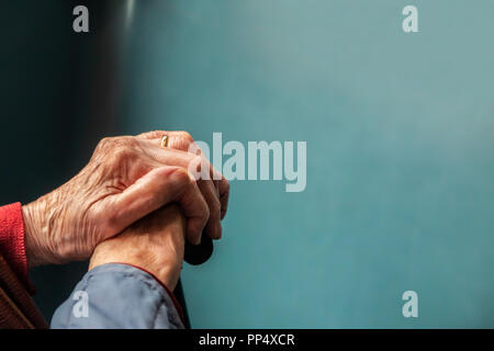 A portrait of an old lady's hands clutching a walking stick Stock Photo