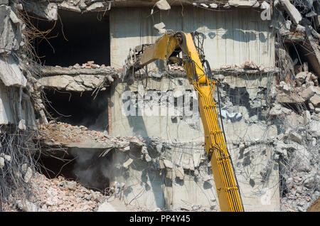 Building demolition and crashing by machinery for new construction. Industry. Stock Photo