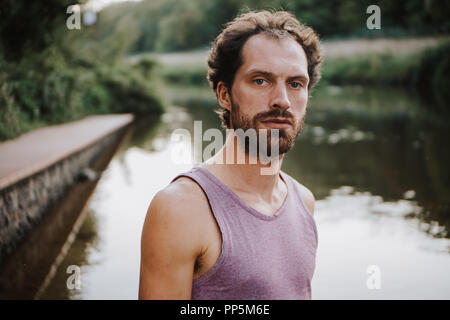 Portrait of bearded caucasian man standing in the middle of a river Stock Photo