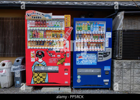 KYOTO, JAPAN - 08 FEB 2018: Coca Cola and Pepsi vending machines full of cold and hot drinks in the street competition concept Stock Photo