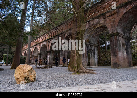 KYOTO, JAPAN - 08 FEB 2018: Red brick bridge in Nanzen-ji Temple surrounded by trees and forest Stock Photo