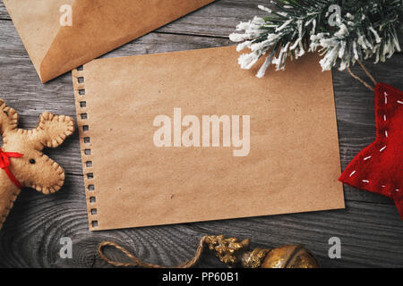 Letter to Santa Claus. Christmas decorations and blank sheet of paper for text on a wooden table, top view Stock Photo
