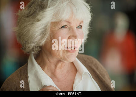 Portrait of nice smilig thoughtful senior woman close up Stock Photo