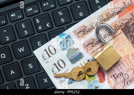 Unlocked padlock and money on a computer keyboard.  Online financial security concept. Stock Photo