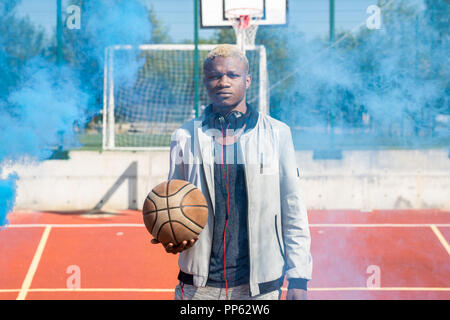 African Basketball Player Posing with Ball Stock Photo