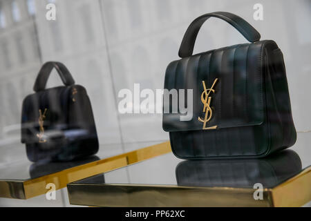 A logo sign outside of a Yves Saint Laurent retail store in Munich, Germany, on September 2, 2018. Stock Photo