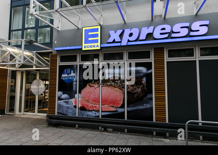 A logo sign outside of an Edeka Express retail grocery store in Munich, Germany, on September 2, 2018. Stock Photo