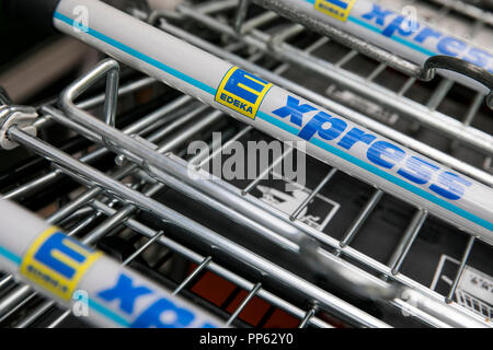 A logo sign outside of an Edeka Express retail grocery store in Munich, Germany, on September 2, 2018. Stock Photo