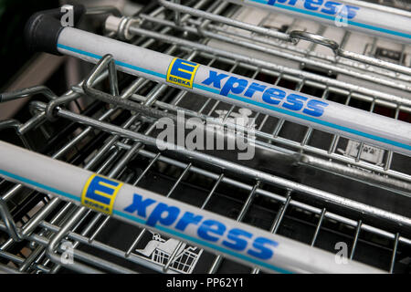 A logo sign outside of an Edeka Express retail grocery store in Munich, Germany, on September 2, 2018. Stock Photo