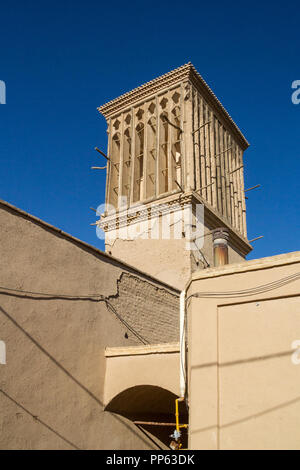 typical Windtower made of clay taken in the streets of Yazd, iran. These towers, aimed at cooling down buildings in the desert, are an icon of the Per Stock Photo