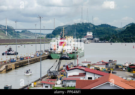 Ships transiting the Miraflores Locks.  Pedro Miguel Locks is seen in the distance, the same as the Centenary Bridge on the left. Stock Photo