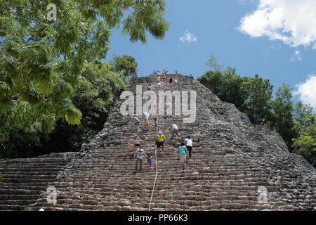 tourists who visit the archaeological site of Coba in Mexico with its beautiful 45-meter-high pyramid where climbing is at the risk of the tourist him Stock Photo