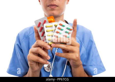 Closeup of female hospital nurse or doctor holding colorful pills tablets as treatment prescription concept isolated on white background