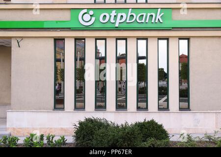 KESZTHELY, HUNGARY - AUGUST 11: People reflect in OTP Bank branch on August 11, 2012 in Keszthely, Hungary. OTP is the biggest commercial Hungarian ba Stock Photo