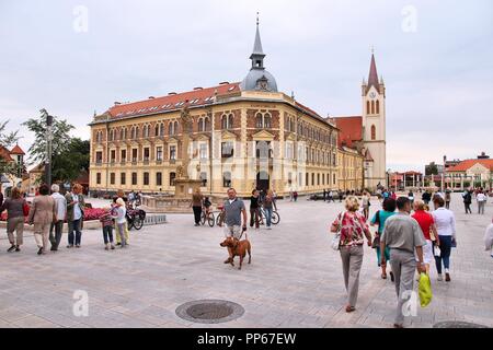 KESZTHELY, HUNGARY - AUGUST 11: Tourists visit main square on August 11, 2012 in Keszthely, Hungary. In 2011 tourism receipts in Hungary brought 4.03  Stock Photo