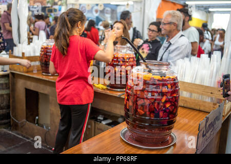 woman serving Sangria wine drink with fresh fruits, Portugal, Lisbon. Stock Photo