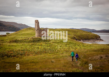 2 girls walking towards an old castle ruin Stock Photo
