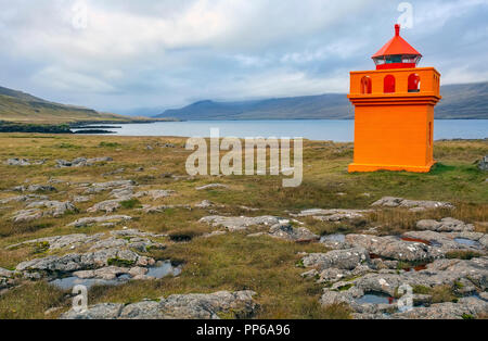 The tiny, orange Hafnarnes lighthouse of eastern Iceland. Stock Photo