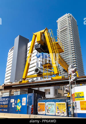 Yellow overhead crane at subway construction site in Tel Aviv, Israel Stock Photo