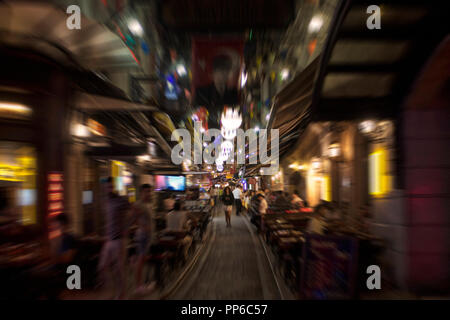 Blurry motion image of people walking on a street in Taksim /Beyoglu area at night in Istanbul. Location is a busy nightlife, shopping and dining dist Stock Photo