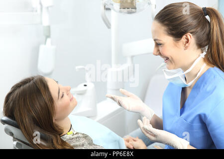 Dentist explaining procedures to a patient in a consultation Stock Photo