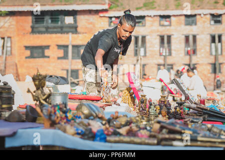 Kathmandu,Nepal - Sep 8,2018: A Street Vendor Getting ready with displaying  tourist Souvenirs at Basantapur durbar Square,Kathmandu. Stock Photo