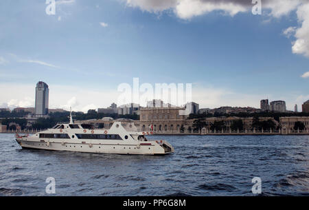 View of a white luxury yacht on Bosphorus, old historical buildings on the European side in Istanbul. Stock Photo