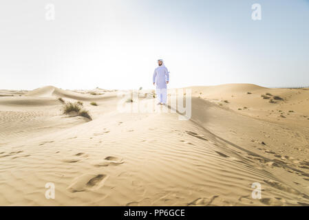 Handsome arabian man with traditional dress in the desert of Dubai ...