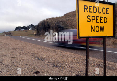 Reduce speed now sign on a country road in New South Wales, Australia Stock Photo