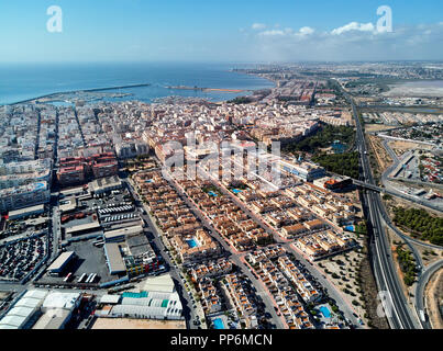 Aerial photo of harbour, residential houses, highways and Mediterranean Sea of Torrevieja. High angle view famous popular travel destinations for trav Stock Photo